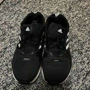 Men’s black Adidas sneakers.